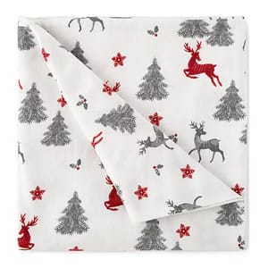 White cotton flannel sheets with a holiday-themed pattern featuring gray and red reindeer, pine trees, and snowflakes.