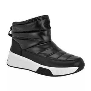 Black Calvin Klein booties with a quilted, puffer-style design, a pull tab at the back, and a chunky white rubber sole featuring subtle branding.