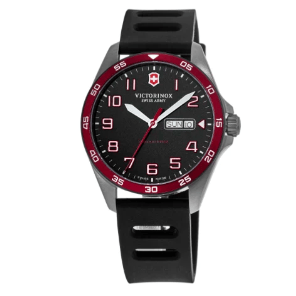 A Victorinox Swiss Army watch with a black dial, white and red markers, red bezel, and a day-date window. It has a black rubber strap and a stainless steel case.