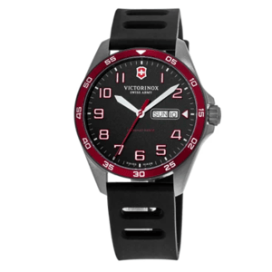 A Victorinox Swiss Army watch with a black dial, white and red markers, red bezel, and a day-date window. It has a black rubber strap and a stainless steel case.