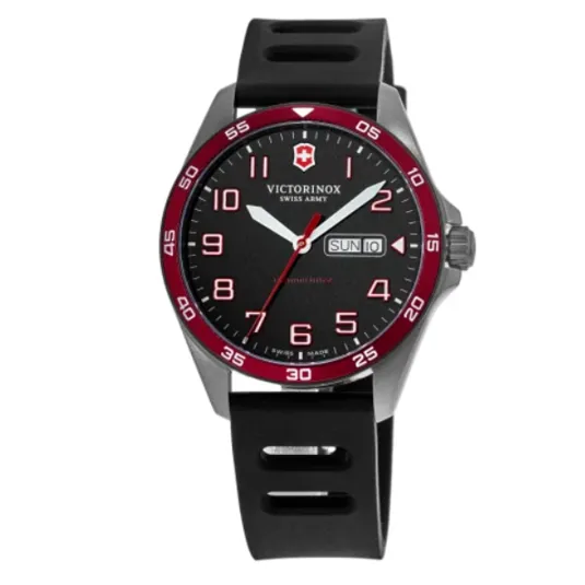 A Victorinox Swiss Army watch with a black dial, white and red markers, red bezel, and a day-date window. It has a black rubber strap and a stainless steel case.