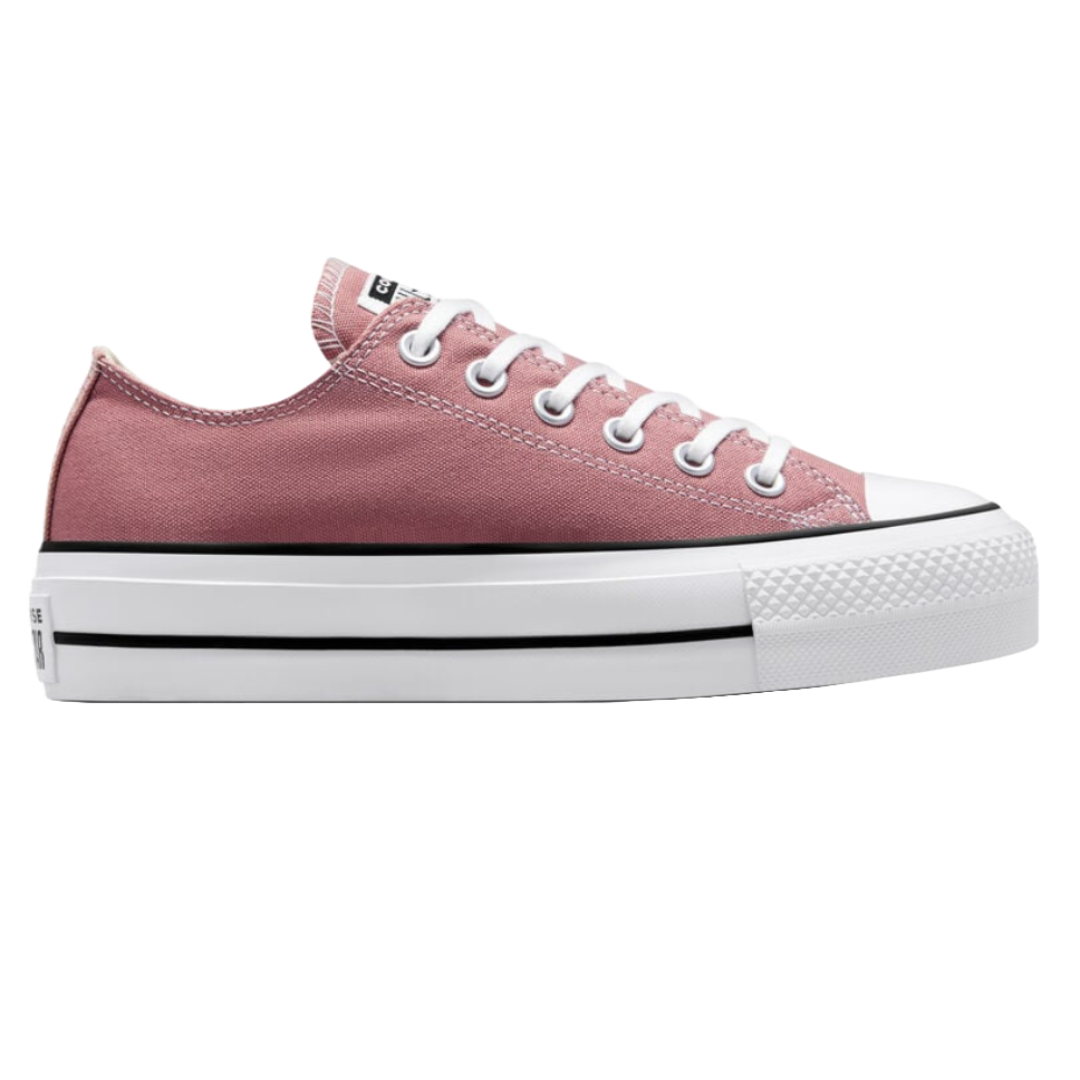 Platform sneaker in dusty pink with white laces, a thick white sole, and black stripe detailing.