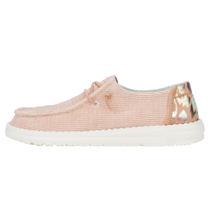 Wendy Corduroy Leo Shoes are casual, slip-on sneakers in a soft blush color with a textured upper, white sole, and decorative lacing. The back features a multicolored leopard print accent.