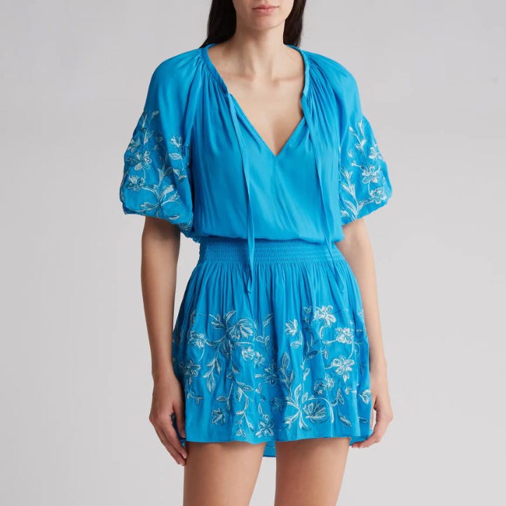 Bright blue short dress with a V-neckline, puffed sleeves, and floral embroidery.