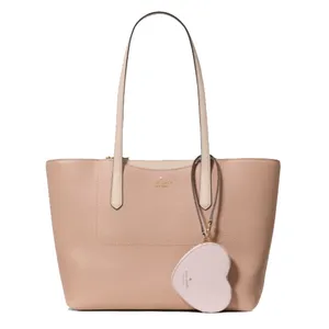 A blush pink tote bag with dual handles and a heart-shaped wristlet attached.
