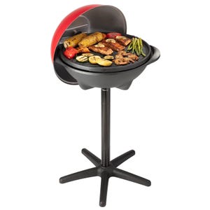 An electric grill with a red lid, black round cooking surface with grilled food items, and a single pedestal stand with a four-legged base.