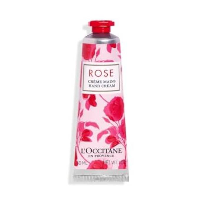 L'Occitane Rose Hand Cream is presented in a 30ml tube with a floral rose design. The packaging is pink with red accents, featuring the text \“Rose Crème Mains Hand Cream\“ and \“L'Occitane en Provence.\“