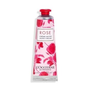 L'Occitane Rose Hand Cream is presented in a 30ml tube with a floral rose design. The packaging is pink with red accents, featuring the text \“Rose Crème Mains Hand Cream\“ and \“L'Occitane en Provence.\“