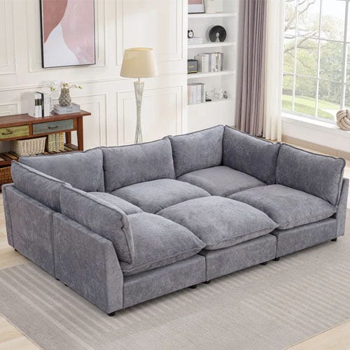 A grey modular sectional in a white living room.
