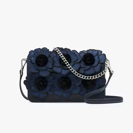 Navy blue crossbody bag with a floral design featuring 3D flowers and a chain strap with a matching navy shoulder rest.