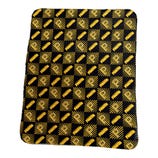 A black and yellow patterned blanket featuring a repeating design of a letter \“R\“ and a stylized stripe pattern arranged in alternating squares.