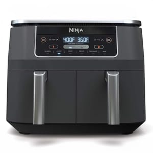A Ninja Dual-Basket Air Fryer with a digital display showing two different temperatures for each basket, designed for cooking multiple foods simultaneously.
