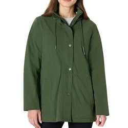 A woman is wearing a green hooded raincoat with snap buttons and a drawstring hood. The coat is paired with dark pants.