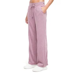 Pink wide-leg sweatpants with a drawstring waist, pockets, and white sneakers.