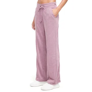 Pink wide-leg sweatpants with a drawstring waist, pockets, and white sneakers.