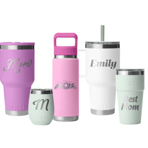 Five YETI drinkware items are shown, including mugs and a bottle, in pastel colors. They feature custom engravings like \“Mom,\“ \“Emily,\“ and \“Best Mom.\“