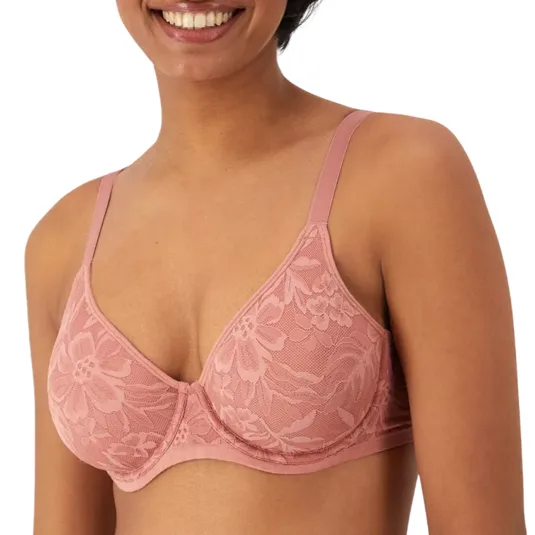 A woman is wearing a pink lace bra with underwire support and floral patterns. The design features thin adjustable straps.