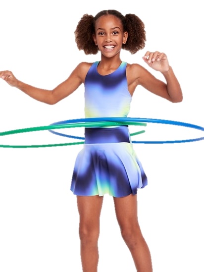 A smiling girl is using two hula hoops while wearing a blue and green gradient dress with a flared skirt.