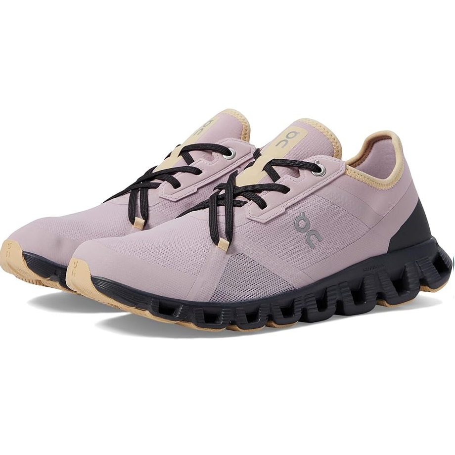 A pair of lavender running shoes with a black sole and beige accents.