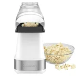 A white Cuisinart popcorn maker is shown with a clear top, accompanied by a bowl of freshly popped popcorn.