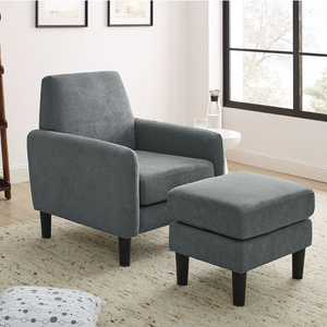 A grey fabric armchair with matching ottoman against a light-colored wall near a window.