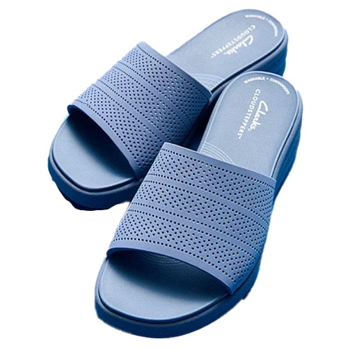 Blue Clarks Drift Twist Slide Sandals featuring perforated straps and a slip-on design. They offer comfort with a cushioned footbed and have a wide fit.