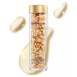 Elizabeth Arden Advanced Ceramide Capsules Daily Youth Restoring Serum in a clear tube with gold capsules and creamy liquid splashes in the background.