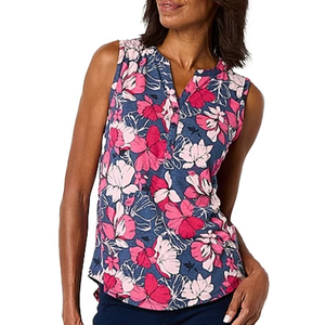 Sleeveless floral print blouse with pink and white flowers on a blue background, featuring a V-neck and a relaxed fit.