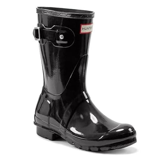 Black glossy rubber rain boot with a buckle and a label that reads \“Hunter\“.