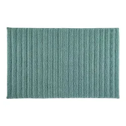 A rectangular, textured bath mat with a ribbed pattern in a teal color.