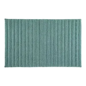 A rectangular, textured bath mat with a ribbed pattern in a teal color.