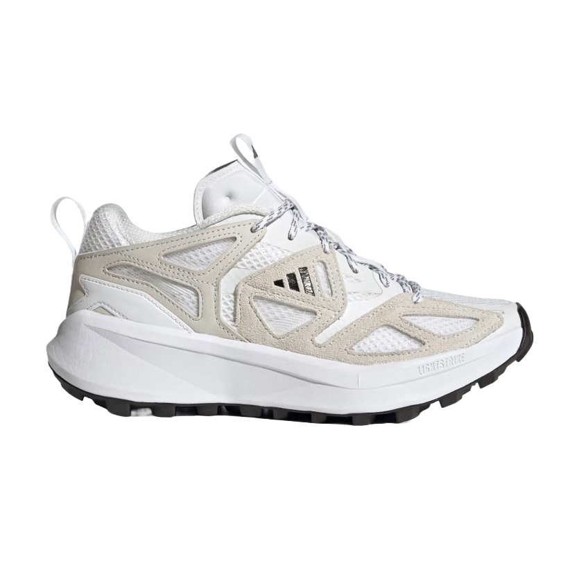 Adidas outdoor trail shoes in white and beige with mesh and suede overlays, featuring a robust sole with a lug pattern for traction and LIGHTSTRIKE cushioning.
