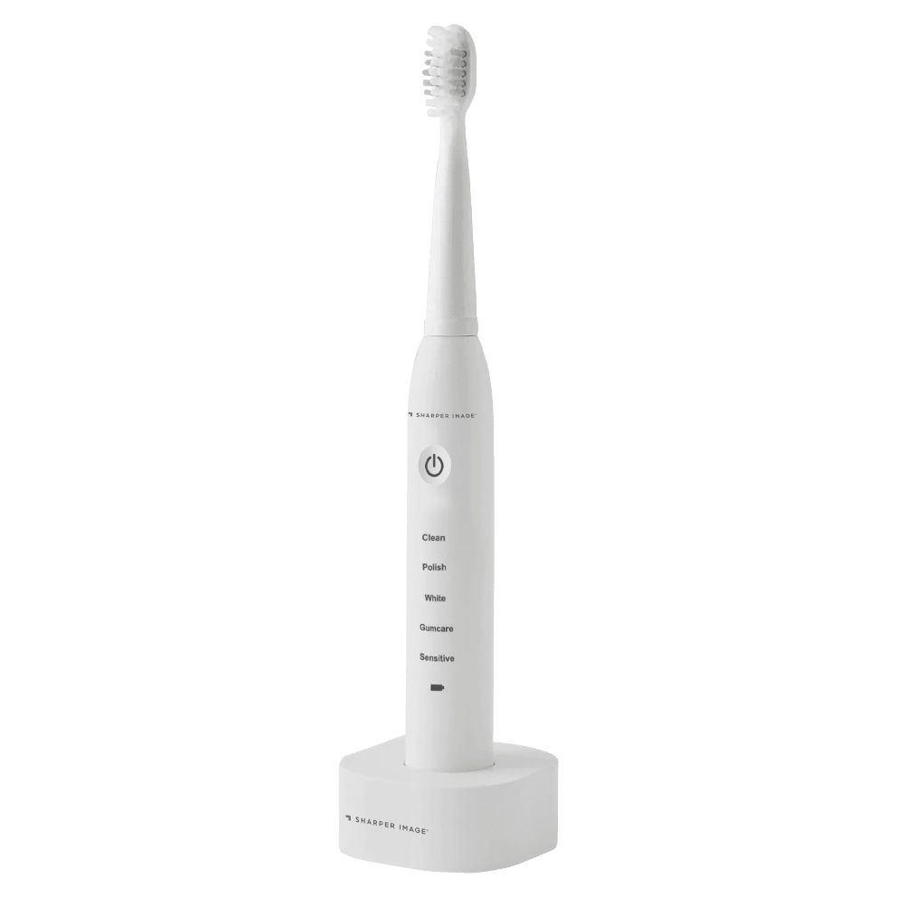 An electric toothbrush from Sharper Image with modes for Clean, Polish, White, Gumcare, and Sensitive, featuring a power button and a charging base.
