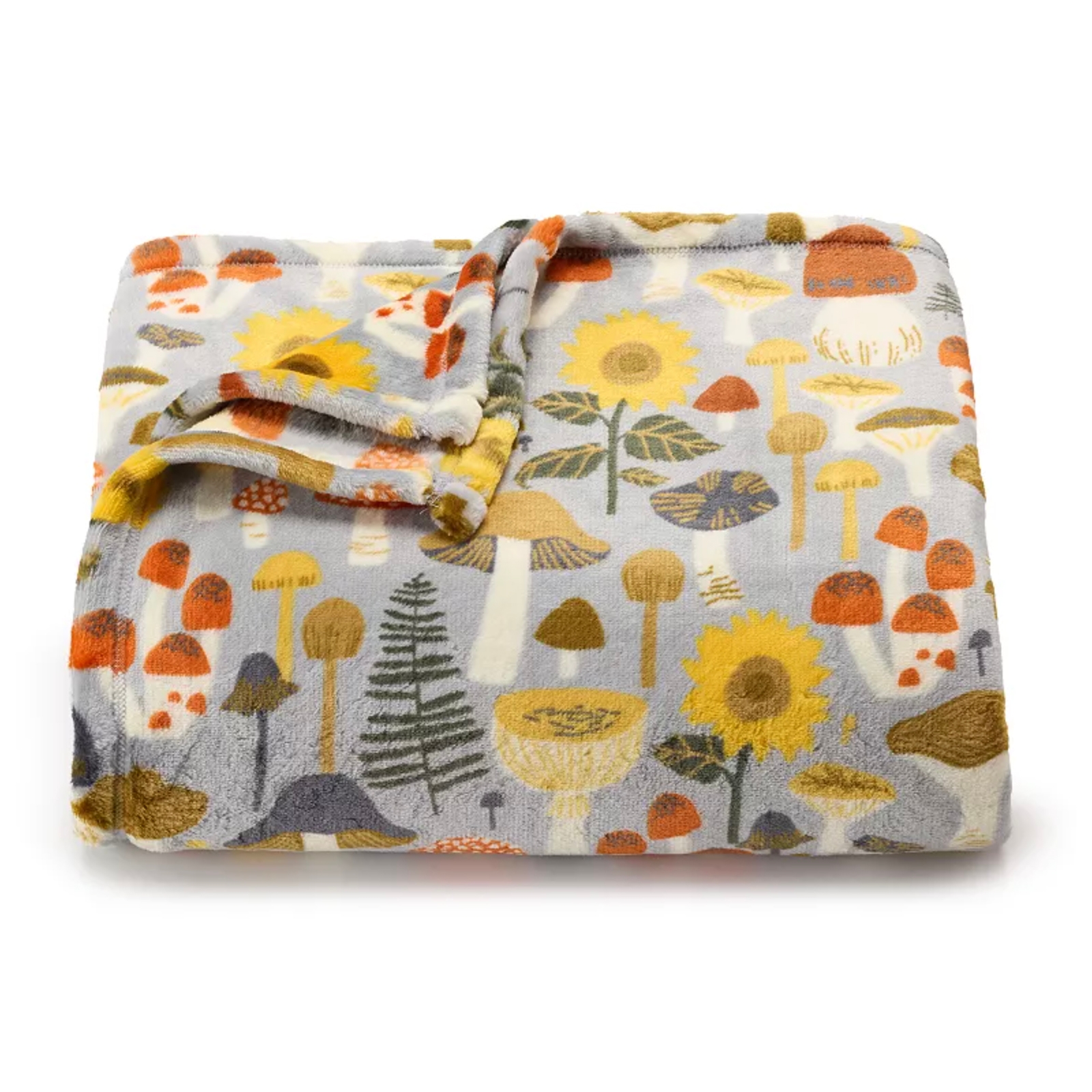 Plush blanket with a colorful print featuring mushrooms, sunflowers, and foliage on a gray background.