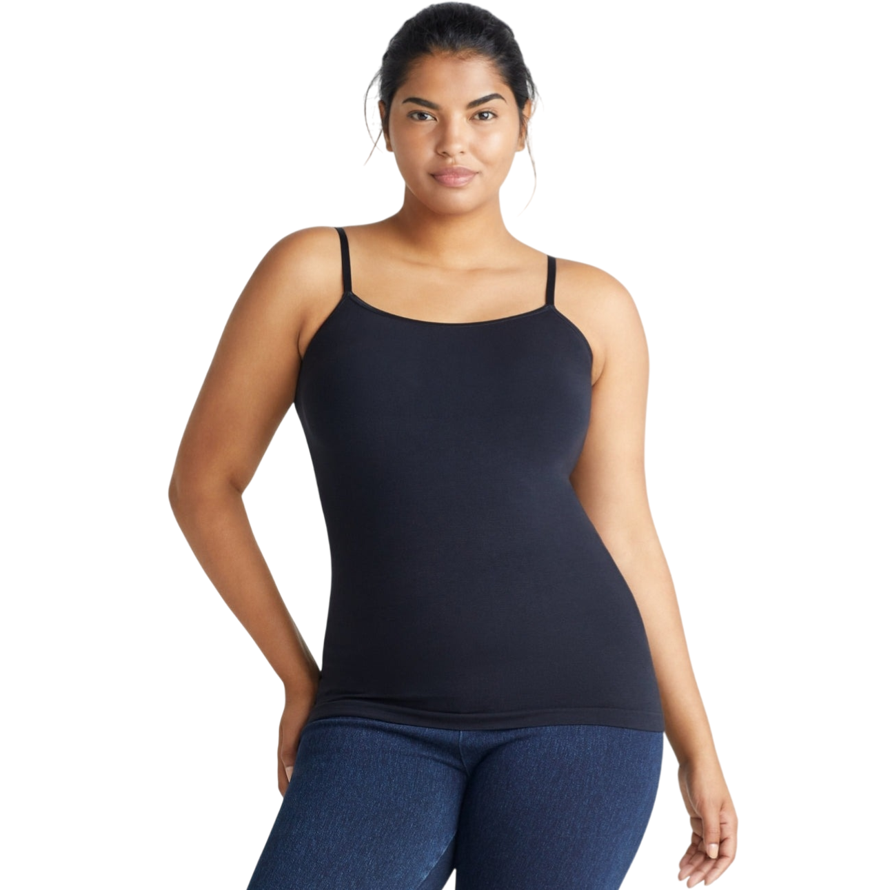 A woman wearing a black camisole with spaghetti straps and dark blue jeans.