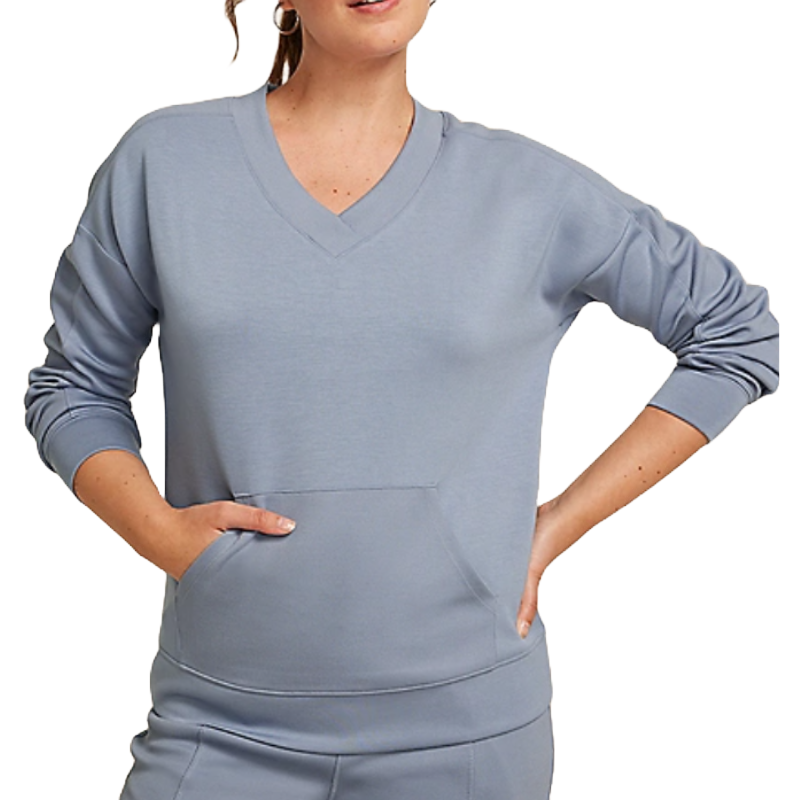 A woman is wearing a light blue V-neck pullover with long sleeves, featuring a front pocket.