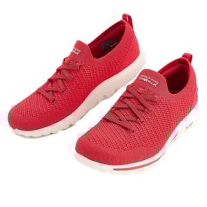A pair of red slip-on athletic shoes with knitted mesh uppers, white soles, and elastic laces.