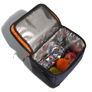 Insulated lunch box with orange trim, holding a patterned thermos and fruits: an apple, orange, and grape.