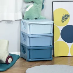 Stacked blue storage containers topped with a green dinosaur plush, next to a colorful abstract art piece, on a wooden floor with a rocking toy and cushion nearby.