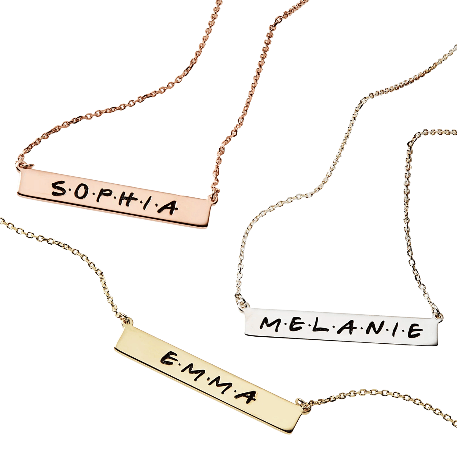 Three necklaces with rectangular pendants are shown, each engraved with a name: \“SOPHIA\“ on a rose gold chain, \“EMMA\“ on a gold chain, and \“MELANIE\“ on a silver chain.