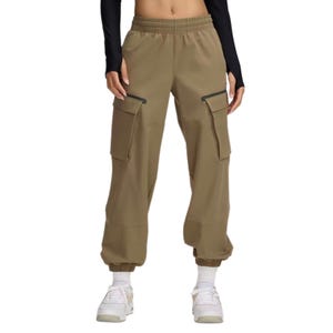 Khaki cargo pants with elastic cuffs and waistband, featuring large side pockets, worn with a black long-sleeve top and white sneakers.