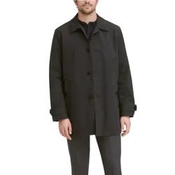 A man is wearing a black button-up coat with a classic collar and adjustable cuffs, paired with dark gray trousers.