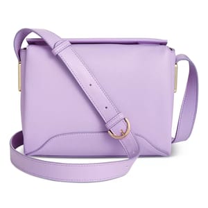 Lavender crossbody bag with a smooth finish, adjustable strap, and gold-tone hardware.
