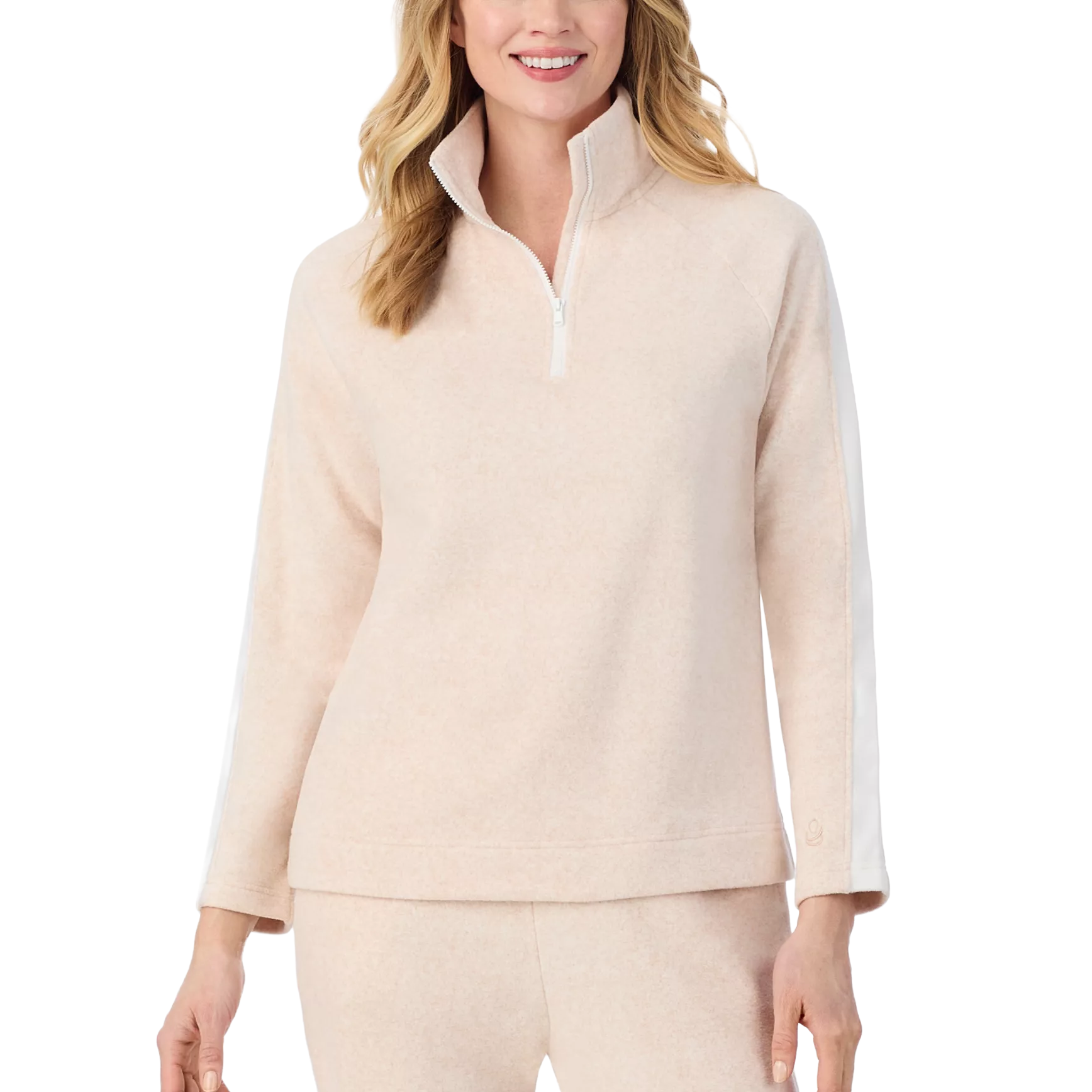 A woman is wearing a light beige quarter-zip pullover with long sleeves and a high collar. The sleeves have a white stripe detail.