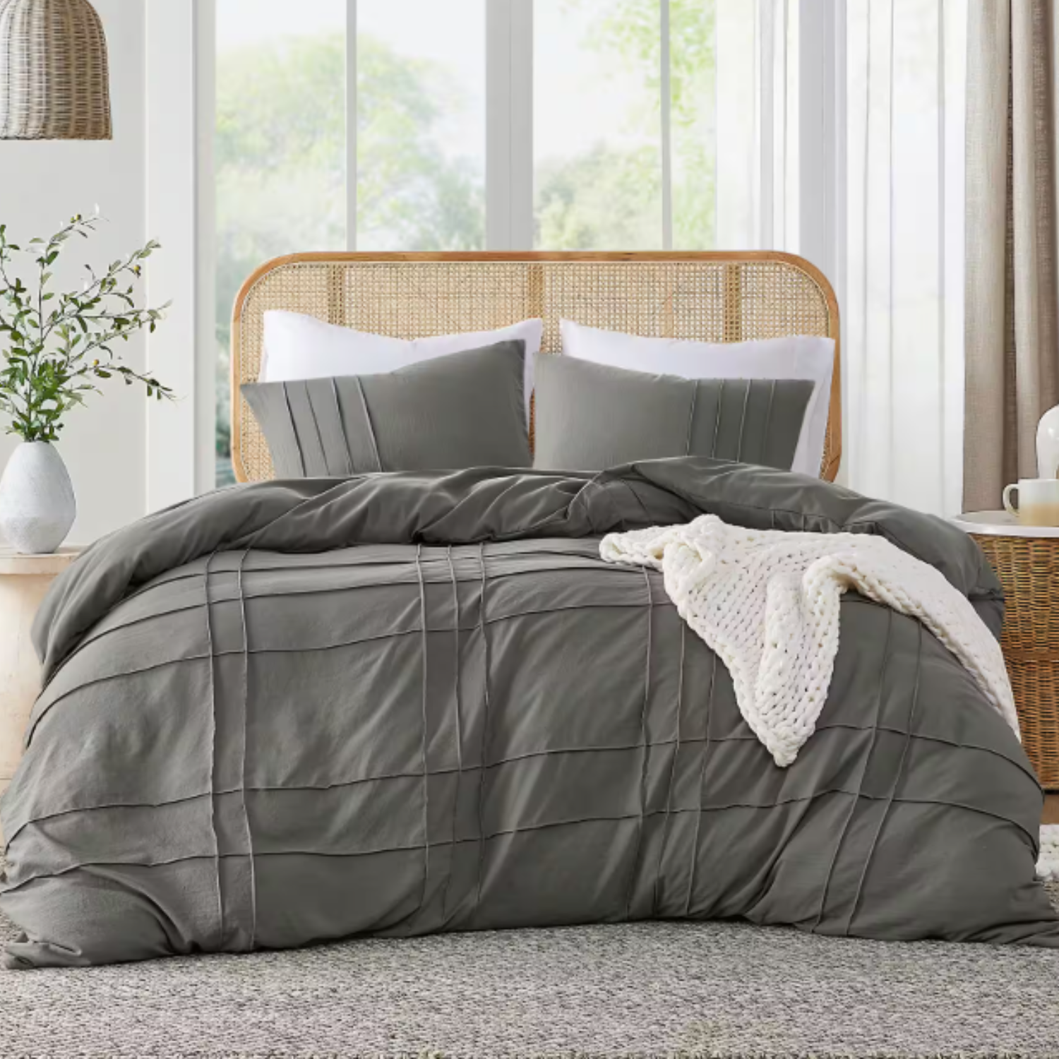 A 3-piece king duvet cover set includes a grey duvet cover with a textured grid pattern and two matching pillow shams, complemented by a white knitted blanket. The set is displayed in a cozy bedroom setting with a wicker headboard and neutral decor.