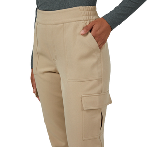 Beige cargo pants made from soft stretch fabric, featuring a flat waistband and multiple pockets, including a side cargo pocket.