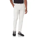 A person is wearing slim-fit white pants paired with black sneakers and a black top.