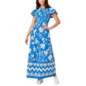 Blue floral maxi dress by St. John's Bay featuring white floral patterns, short ruffled sleeves, and a chevron border design at the hem. Paired with white sneakers.