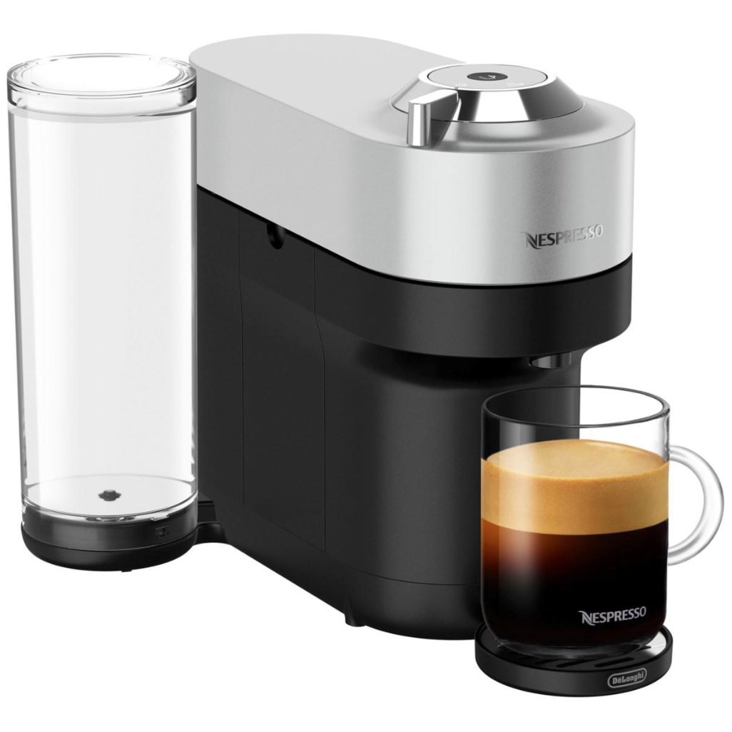 Nespresso coffee machine with a cup of espresso. The machine features a sleek design with a water tank on the side.