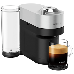 Nespresso coffee machine with a cup of espresso. The machine features a sleek design with a water tank on the side.